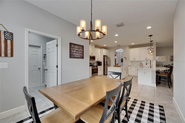 dining space with a chandelier, baseboards, light tile patterned floors, and recessed lighting