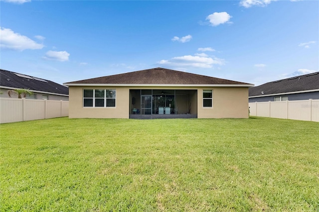 rear view of property featuring a sunroom, stucco siding, and roof with shingles