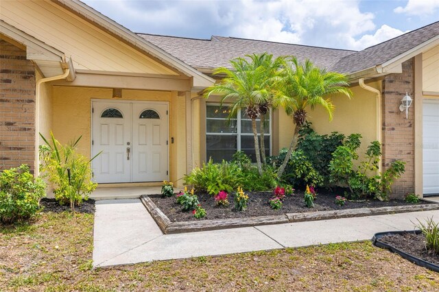 1426 Buckner Rd, Valrico, FL 33596 - property entrance featuring brick siding and a shingled roof