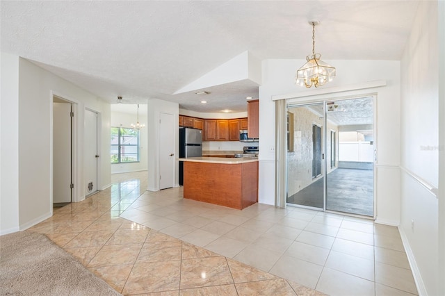 1426 Buckner Rd, Valrico, FL 33596 - kitchen featuring a chandelier, brown cabinets, vaulted ceiling, stainless steel appliances, and light countertops