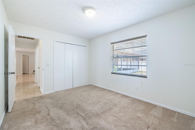 1426 Buckner Rd, Valrico, FL 33596 - unfurnished bedroom with light carpet, a closet, baseboards, and a textured ceiling