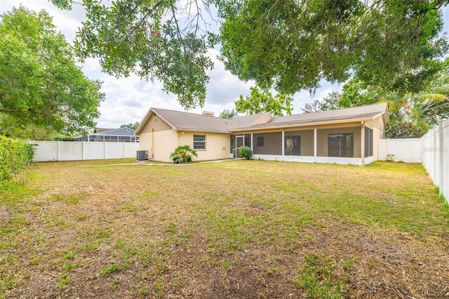 1426 Buckner Rd, Valrico, FL 33596 - rear view of house with a sunroom and central AC unit