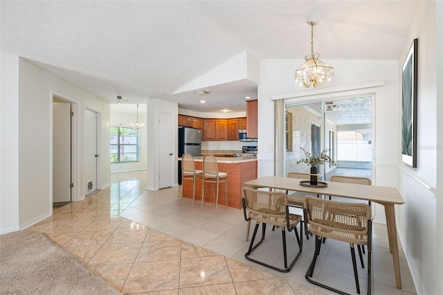 1426 Buckner Rd, Valrico, FL 33596 - dining space featuring a chandelier, vaulted ceiling, baseboards, and light marble finish flooring