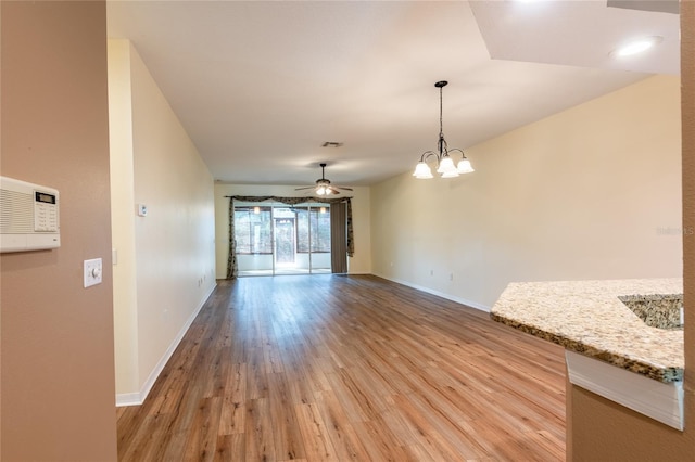 19025 Callaway Ct, Tampa, FL 33647 - unfurnished dining area with light wood-style floors, baseboards, a chandelier, and ceiling fan