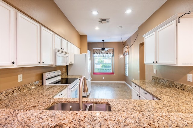 19025 Callaway Ct, Tampa, FL 33647 - kitchen with white appliances, recessed lighting, light stone counters, and white cabinets