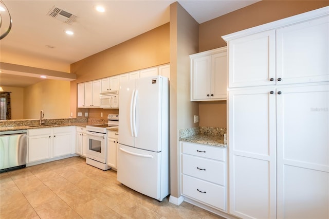 19025 Callaway Ct, Tampa, FL 33647 - kitchen featuring white appliances, a sink, white cabinetry, light stone countertops, and recessed lighting