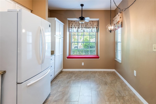19025 Callaway Ct, Tampa, FL 33647 - kitchen with freestanding refrigerator, white cabinets, a ceiling fan, and baseboards