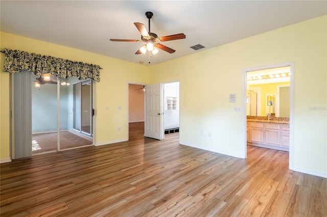 19025 Callaway Ct, Tampa, FL 33647 - unfurnished bedroom featuring light wood-style flooring, a sink, ensuite bath, ceiling fan, and baseboards