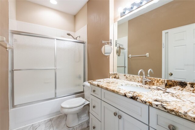 19025 Callaway Ct, Tampa, FL 33647 - bathroom featuring vanity, toilet, enclosed tub / shower combo, marble look tiles, and recessed lighting