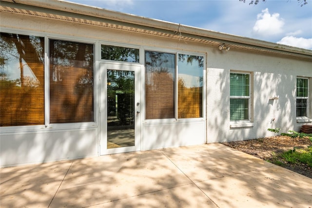 19025 Callaway Ct, Tampa, FL 33647 - view of side of property featuring stucco siding and a patio area