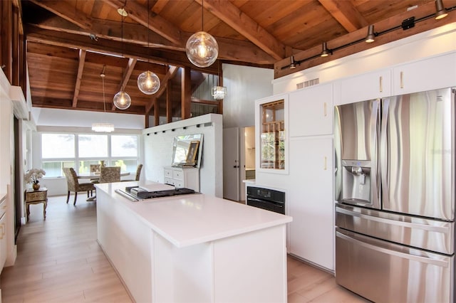 kitchen featuring stainless steel fridge, wood ceiling, a kitchen island, light wood-style floors, and white cabinetry