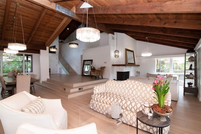 living area featuring a chandelier, wooden ceiling, wood finished floors, beam ceiling, and stairs