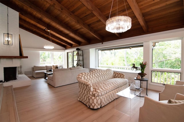 living area with a chandelier, wooden ceiling, a fireplace, plenty of natural light, and wood finished floors