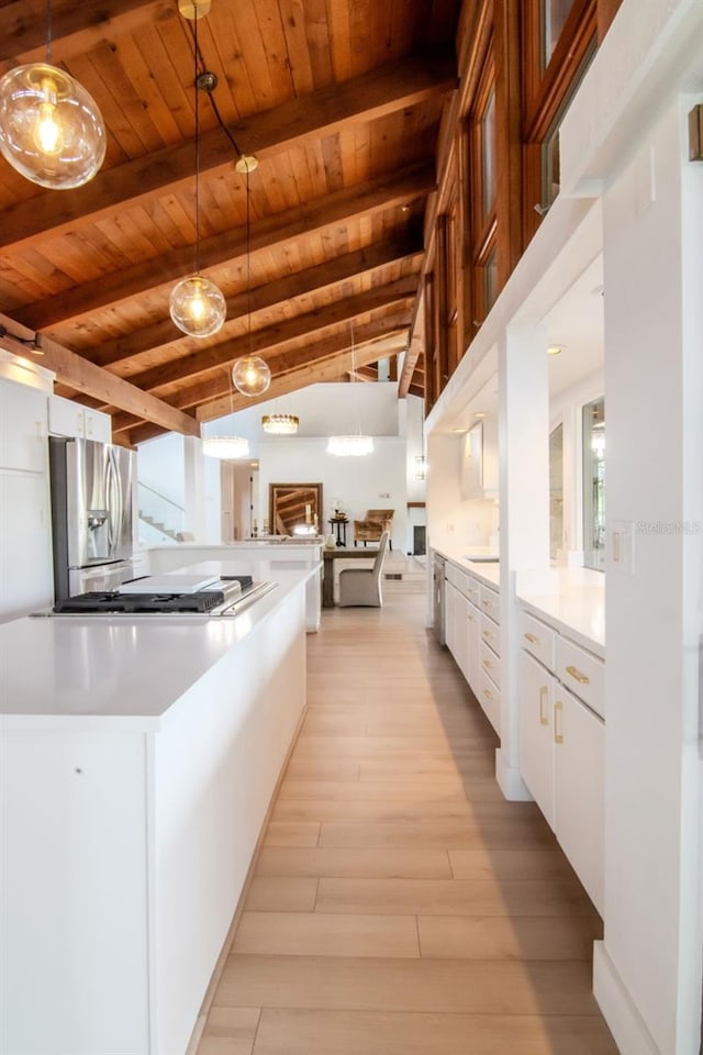 kitchen featuring stainless steel fridge with ice dispenser, wood ceiling, white cabinetry, light wood-type flooring, and beam ceiling