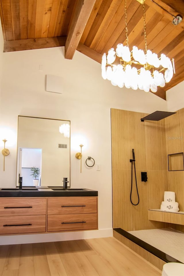 bathroom featuring a tile shower, vanity, a chandelier, wood finished floors, and wood ceiling