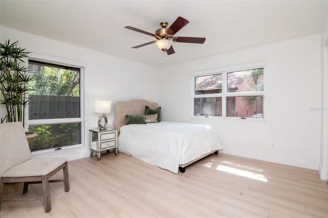bedroom featuring light wood-style floors and ceiling fan