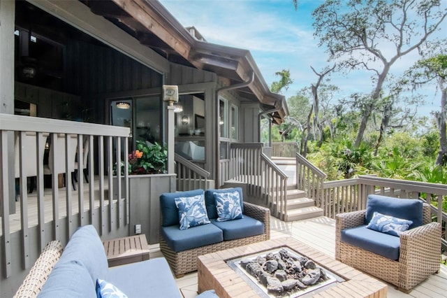 deck with an outdoor living space with a fire pit