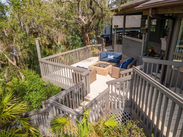 wooden deck with stairs and an outdoor living space with a fire pit