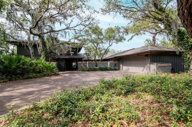 view of front of home featuring driveway, a garage, and board and batten siding