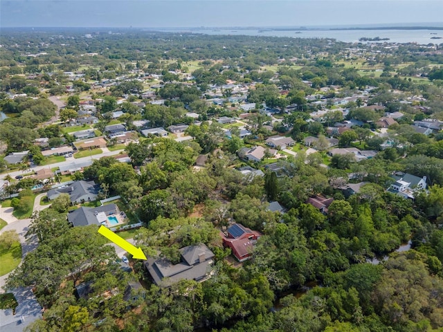 aerial view of property and surrounding area with a nearby body of water
