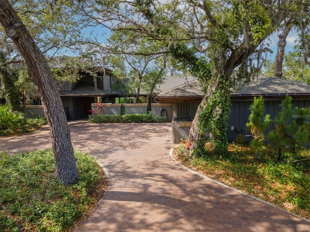 1296 Weybridge Ln, Dunedin, FL 34698 - view of front of home featuring board and batten siding and roof with shingles