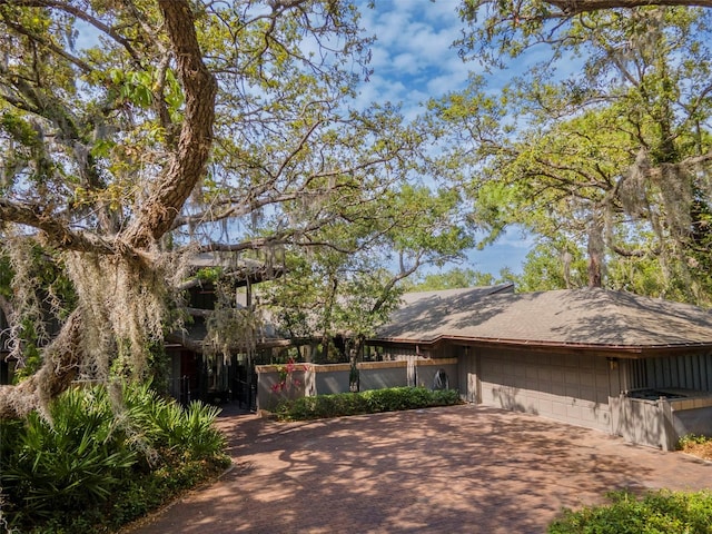 1296 Weybridge Ln, Dunedin, FL 34698 - view of front of house with driveway, a garage, and roof with shingles