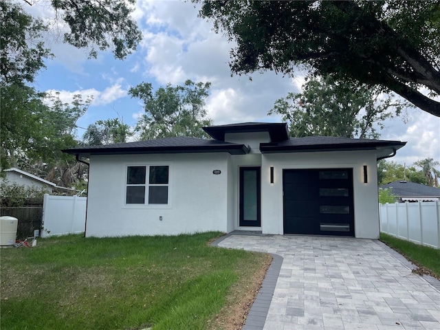 12308 Pittsfield Ave, Tampa, FL 33624 - prairie-style house featuring stucco siding, a garage, and decorative driveway