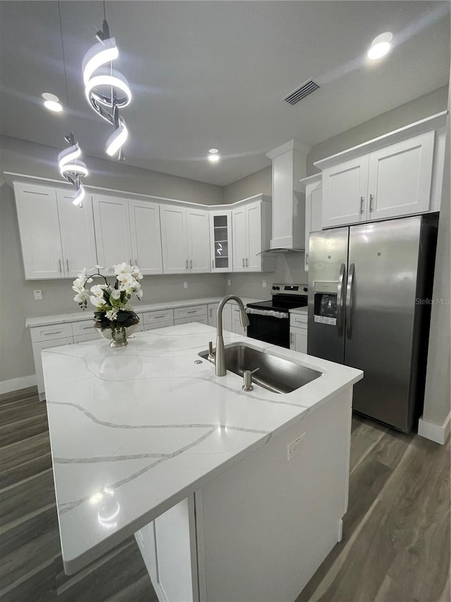 12308 Pittsfield Ave, Tampa, FL 33624 - kitchen with appliances with stainless steel finishes, wall chimney exhaust hood, baseboards, white cabinets, and recessed lighting