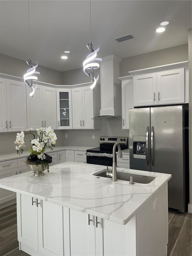 12308 Pittsfield Ave, Tampa, FL 33624 - kitchen with appliances with stainless steel finishes, wall chimney range hood, a sink, a center island with sink, and recessed lighting