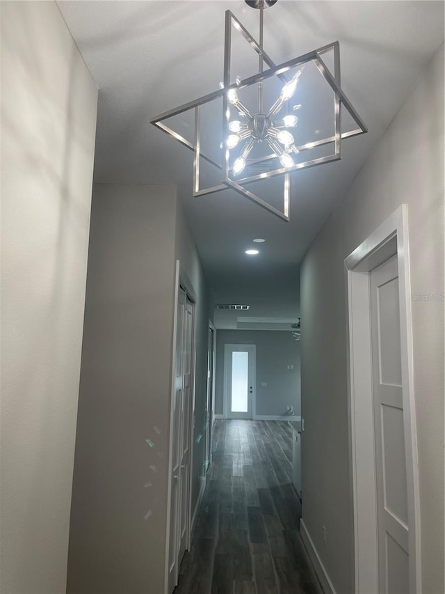 12308 Pittsfield Ave, Tampa, FL 33624 - hallway with dark wood-type flooring, baseboards, and a chandelier