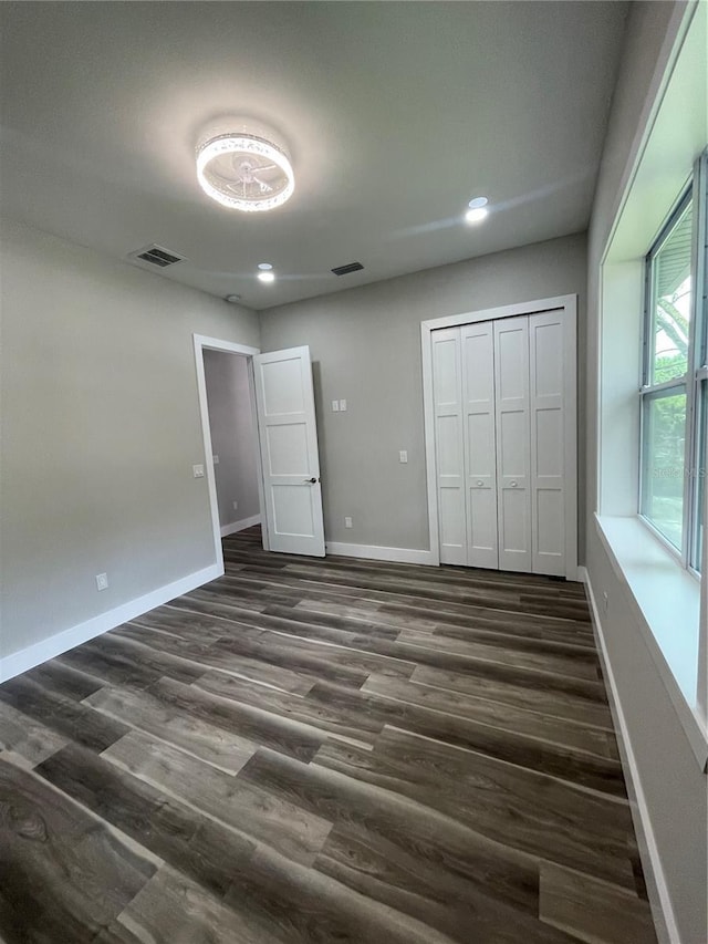 12308 Pittsfield Ave, Tampa, FL 33624 - unfurnished bedroom with dark wood-style floors, baseboards, a closet, and recessed lighting