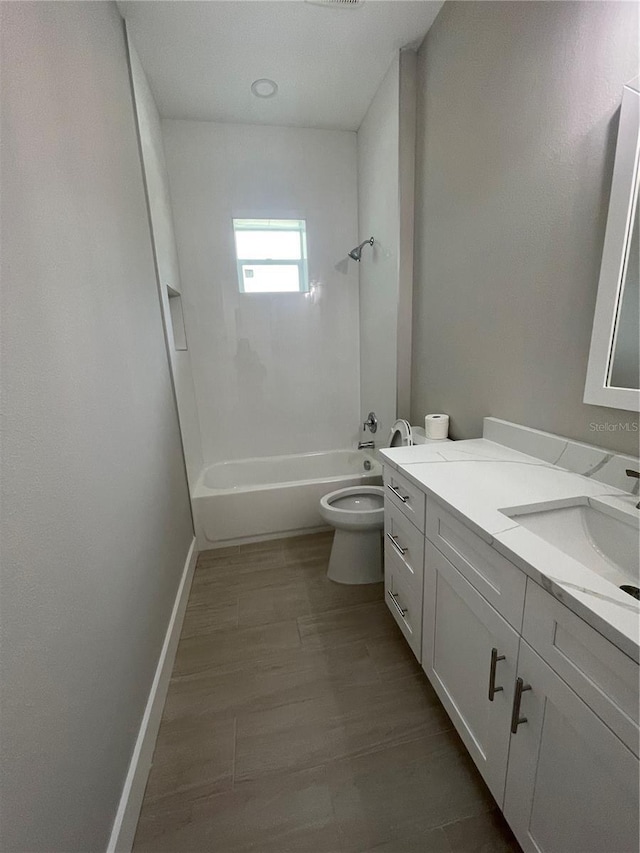 12308 Pittsfield Ave, Tampa, FL 33624 - bathroom featuring toilet, shower / washtub combination, vanity, and baseboards