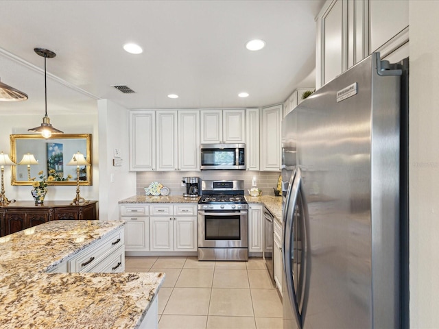 5980 Terrace Park Dr N Unit 214, Saint Petersburg, FL 33709 - kitchen with appliances with stainless steel finishes, tasteful backsplash, light tile patterned floors, white cabinetry, and recessed lighting
