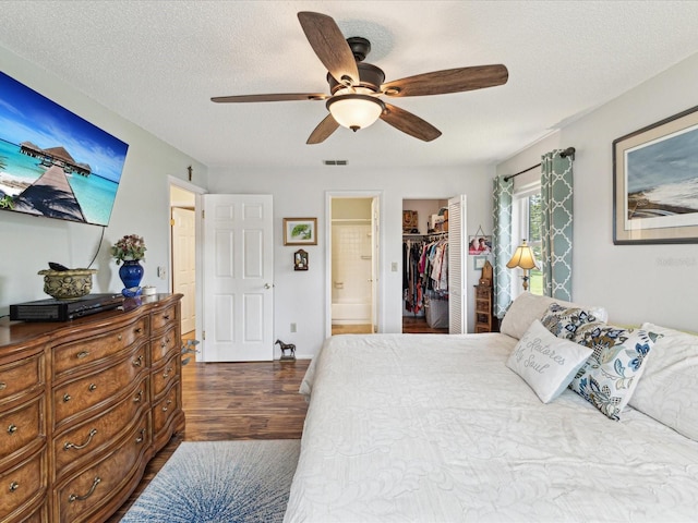 5980 Terrace Park Dr N Unit 214, Saint Petersburg, FL 33709 - bedroom featuring wood finished floors, a closet, a spacious closet, connected bathroom, and ceiling fan