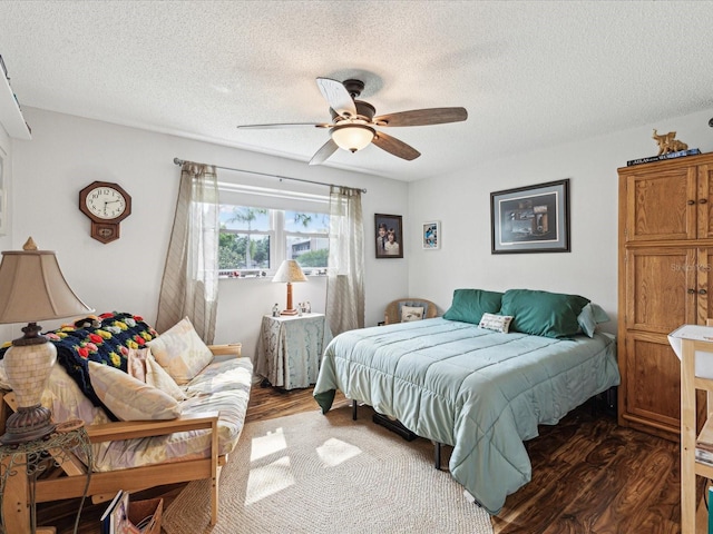 5980 Terrace Park Dr N Unit 214, Saint Petersburg, FL 33709 - bedroom featuring dark wood-type flooring, a textured ceiling, and a ceiling fan
