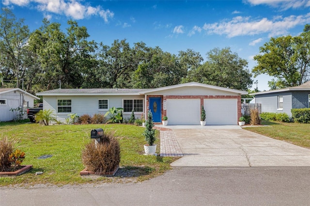 308 Jeanal Pl, Tampa, FL 33612 - single story home with a front lawn, an attached garage, driveway, and brick siding