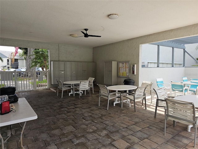 view of patio featuring mail area and fence