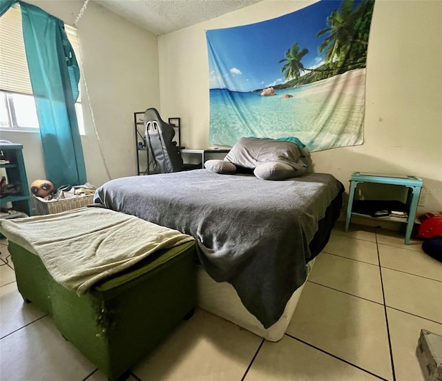 tiled bedroom with a textured ceiling