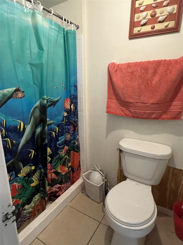 bathroom with toilet, a shower with shower curtain, and tile patterned floors