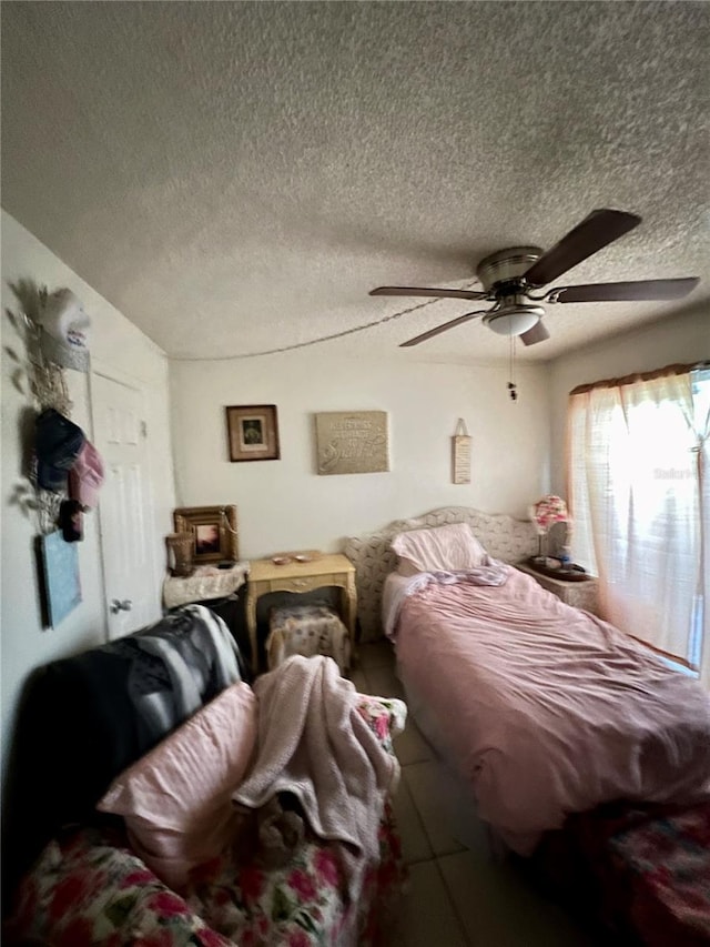 11201 122nd Ave Unit 129, Largo, FL 33778 - bedroom featuring a textured ceiling and a ceiling fan