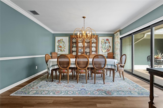 4009 Carrollwood Village Dr, Tampa, FL 33618 - dining area with a chandelier, ornamental molding, wood finished floors, and baseboards