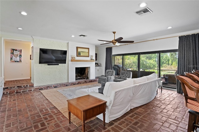 4009 Carrollwood Village Dr, Tampa, FL 33618 - living room with brick floors, recessed lighting, ornamental molding, a ceiling fan, and a brick fireplace