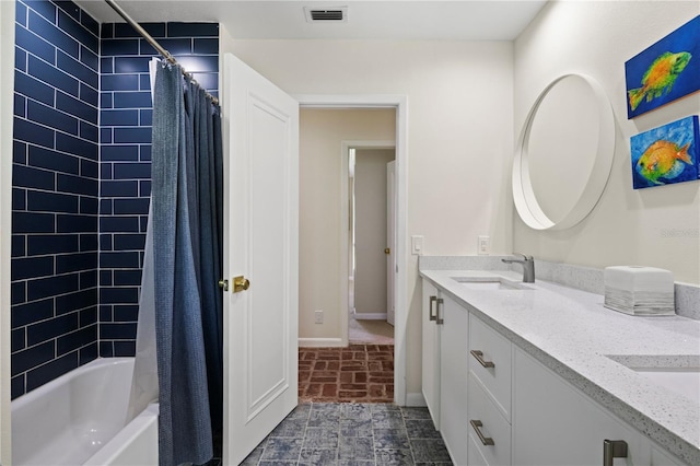 4009 Carrollwood Village Dr, Tampa, FL 33618 - bathroom with double vanity, baseboards, shower / bath combo, and brick patterned floors