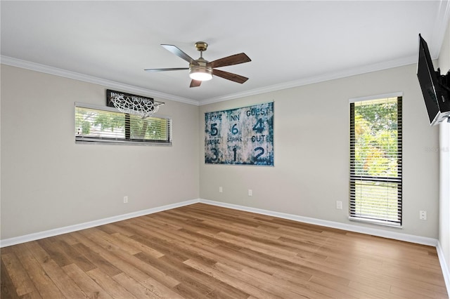 4009 Carrollwood Village Dr, Tampa, FL 33618 - spare room with crown molding, a ceiling fan, light wood-style floors, and baseboards