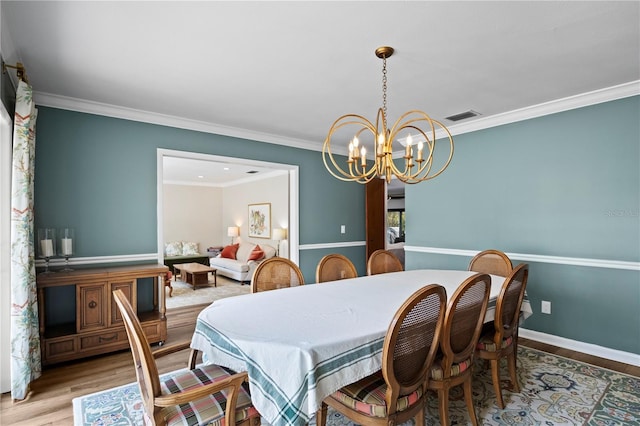 4009 Carrollwood Village Dr, Tampa, FL 33618 - dining space with a chandelier, wood finished floors, ornamental molding, and baseboards