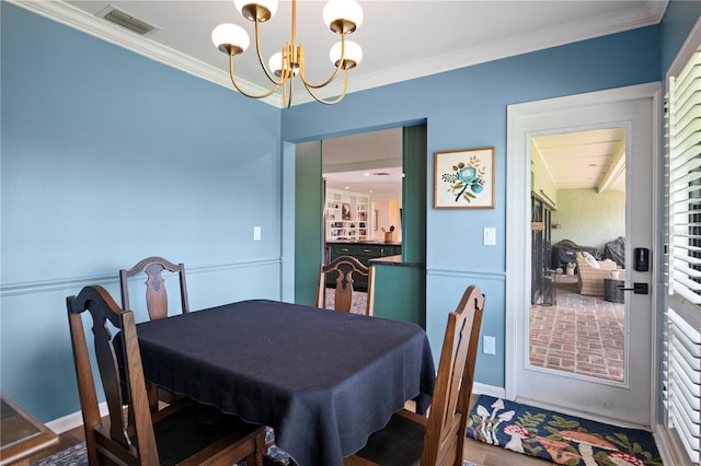 4009 Carrollwood Village Dr, Tampa, FL 33618 - dining room with a chandelier and ornamental molding