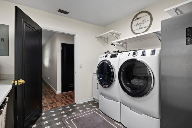 4009 Carrollwood Village Dr, Tampa, FL 33618 - washroom with independent washer and dryer, cabinet space, baseboards, brick patterned flooring, and electric panel