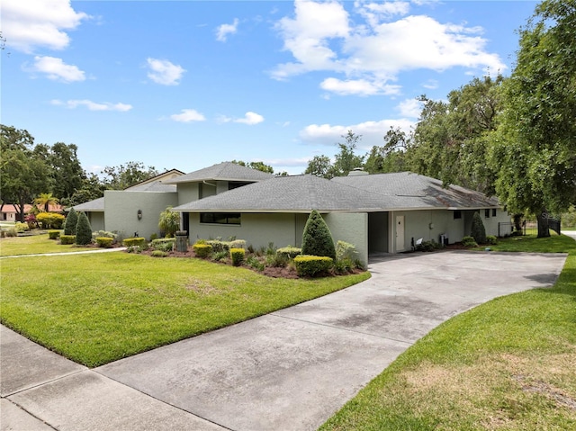 4009 Carrollwood Village Dr, Tampa, FL 33618 - view of front of property with concrete driveway, a front yard, stucco siding, a shingled roof, and an attached carport