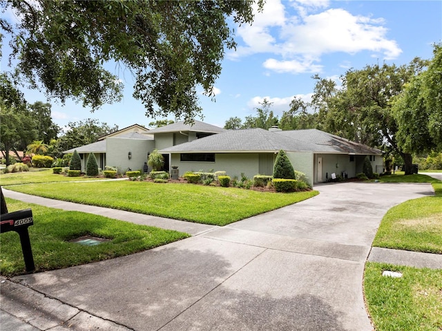 4009 Carrollwood Village Dr, Tampa, FL 33618 - view of front facade with concrete driveway, a front lawn, and stucco siding