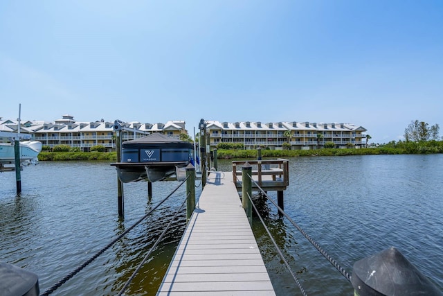 dock with boat lift and a water view